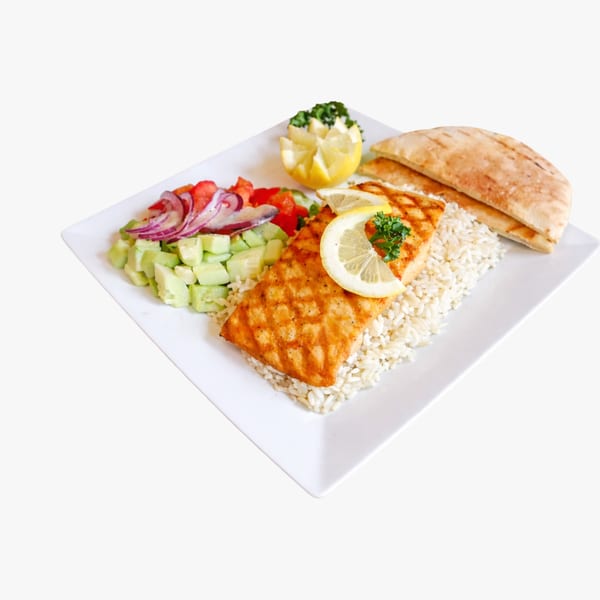 Grilled salmon with rice, cucumber and tomato salad, lemon, and pita bread on a white plate.