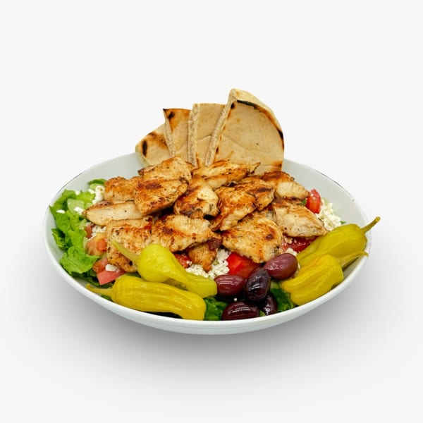 California Pita & Grill's chicken shawarma salad with pita bread, olives, and peppers.