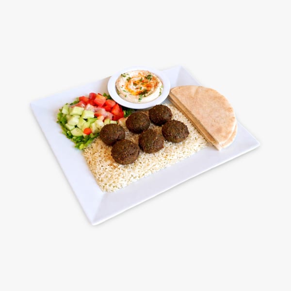 Falafel plate with rice, salad, hummus, and pita bread on a white rectangular plate.
